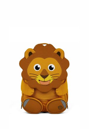 Children's backpack shaped like a smiling lion with a brown mane, yellow face, and round feet with reflective patches.