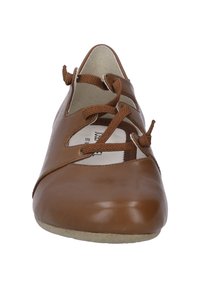 Brown leather flat shoe featuring a rounded toe, cutout design, and lace details on the front. Soft inner lining and flat sole.
