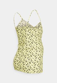Camisola amarela floral com alças finas, apresentando um delicado padrão de flores pretas e um design ajustado, feita de um tecido leve.