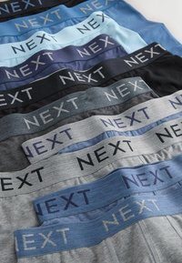 Sous-vêtements pour hommes de différentes couleurs, avec des ceintures élastiques portant le logo "NEXT". Les couleurs comprennent le noir, le bleu, le gris et le bleu clair.