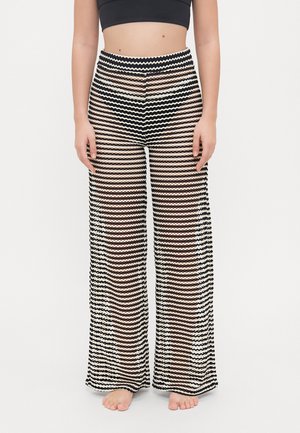 Schwarz-weiße, gemusterte weite Hosen mit einem wellenförmigen Design, das eine durchsichtige Textur und einen hohen Bund aufweist.