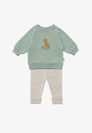 Soft green baby sweatshirt with a sitting cheetah design and light beige ribbed pants with folded cuffs.