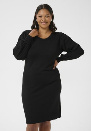 Black knitted dress with a round neckline, long puff sleeves, and a fitted hem. Features vertical ribbed texture on sleeves.