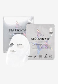 Masque facial en bio-cellulose blanc devant un emballage argenté avec un design d'étoile holographique, présentant les détails du produit en texte noir.