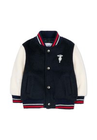 Giacca varsity di lana blu navy con maniche crema, polsini a coste a righe, bottoni a pressione, tasche laterali e un logo circolare sul petto.