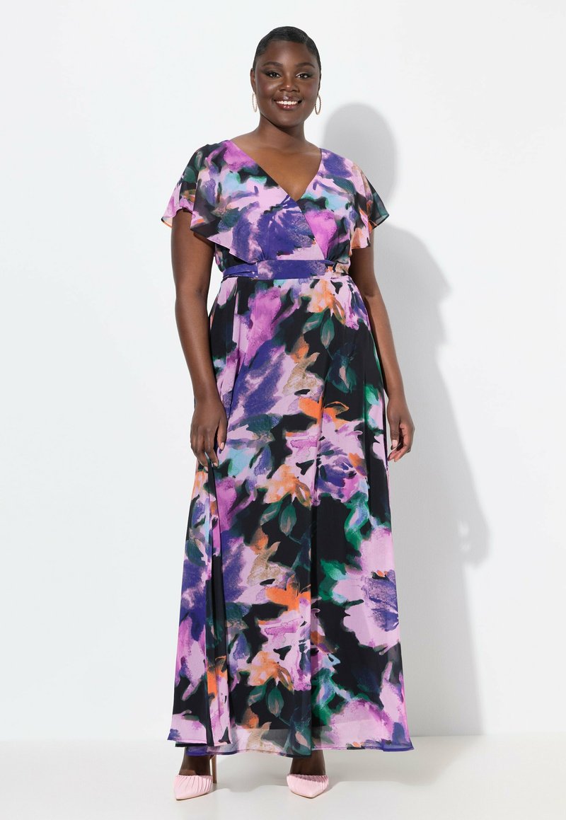 Robe maxi à motif floral dans des nuances de violet, vert et orange. Présente un design enveloppant, des manches flottantes et un détail de taille nouée.