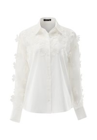 Weiße Hemdbluse mit floraler Stickerei auf den Ärmeln. Weicher Stoff mit glatter Textur und tailliertem Schnitt.