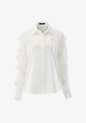 Weiße Hemdbluse mit floraler Stickerei auf den Ärmeln. Weicher Stoff mit glatter Textur und tailliertem Schnitt.