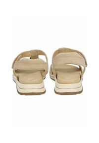 Sandali beige chiaro con soletta imbottita, doppie cinghie regolabili e suola in gomma spessa. Progettati per comfort e supporto.