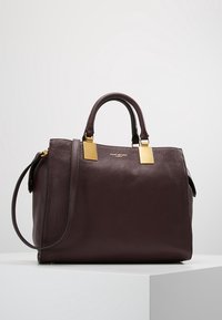 Donker bordeaux lederen handtas met een gestructureerde afwerking, gouden hardware-accenten, dubbele handvatten aan de bovenkant en een afneembare schouderriem.