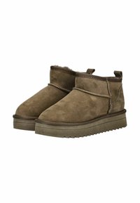 Botas de tobillo de ante marrón con puntera redondeada, paneles laterales elásticos y suelas texturizadas. Cuenta con un forro suave y detalles de costura en la parte superior.