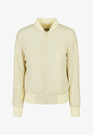 Jasnożółta kurtka bomberka z zamkiem z przodu, ściągaczem przy kołnierzu i mankietach. Wykonana z gładkiego materiału o miękkiej fakturze i elastycznym pasku w talii.