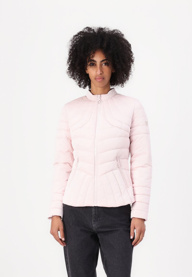 Light pink puffer jacket with a zip closure, features a high collar, diamond quilted texture, and two front pockets. Accents include button details.