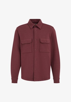 Weinrote Hemdjacke aus weichem Stoff, mit durchgehender Knopfleiste, zwei Brusttaschen und langen Ärmeln mit gesteppten Bündchen.