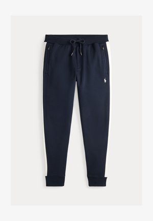 Marinebukser laget av myk stoff med hvite sidelister, glidelåslommer og elastisk midje med snøring.