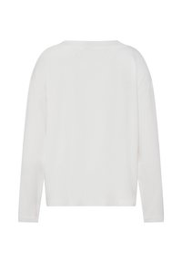 Weißes Langarmoberteil mit lockerem Schnitt, aus weicher Baumwolle. Verfügt über einen breiten Ausschnitt und nahtlose Schultern für eine glatte Silhouette.