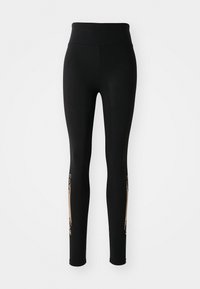 Zwarte legging met een hoge tailleband, voorzien van gouden accenten aan de zijkanten en een gladde, rekbare stoftextuur.