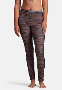 Leggings i ett flerfärgat geometriskt mönster med röd och blå f�ärg, tillverkade av elastisk tyg, med en smidig midja och en åtsittande design.