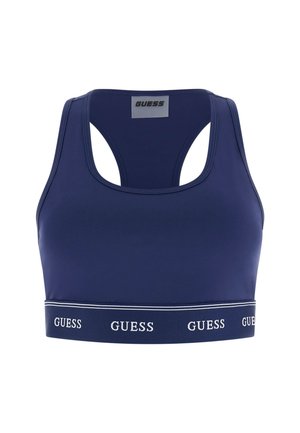 Marineblauer Sport-BH mit Racerback-Design und elastischem Bund unten, der das wiederholte "GUESS"-Logo in weißen Buchstaben zeigt.