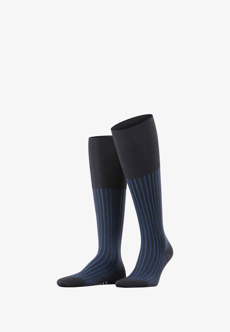 Calze fino al ginocchio con una base blu navy scuro e strisce verticali blu a contrasto. Tessuto a coste nella parte superiore e tessuto liscio nella parte inferiore.
