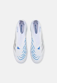 Predator shoes with a white mesh upper, blue and grey wavy lines, slip-on design, and reinforced heel for support and flexibility.
