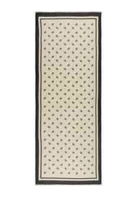 Sciarpa rettangolare color crema con motivo geometrico nero. Rifinita con un bordo scuro e dettagli con frange. Realizzata in tessuto morbido e leggero.