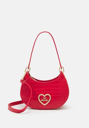 Small red croc-embossed handbag with single handle and gold heart-shaped Love Moschino logo on front.