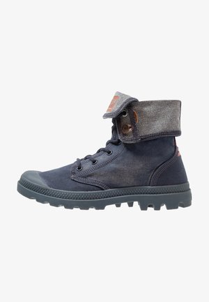 Navy blue ankle boots made of canvas with a rubber sole, featuring a padded gray collar and metal eyelets for laces. Textured design.