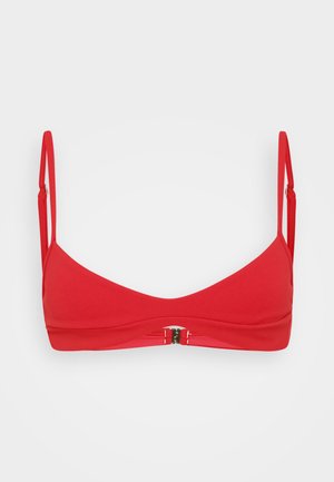 Red bikini top with thin adjustable straps, a smooth texture, and a front clasp closure. Slightly curved design for coverage and support.