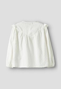 Balta palaidinė su tekstūruotu raštu, raukinėtais pečiais ir elastinėmis rankogaliais. Turi V formos yoke detalę ir surinktą nugaros dalį.