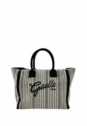 Borsa a tracolla in tessuto a righe con manici neri, bordi neri sfrangiati e ricamo "Gaelle Paris" in nero al centro davanti.