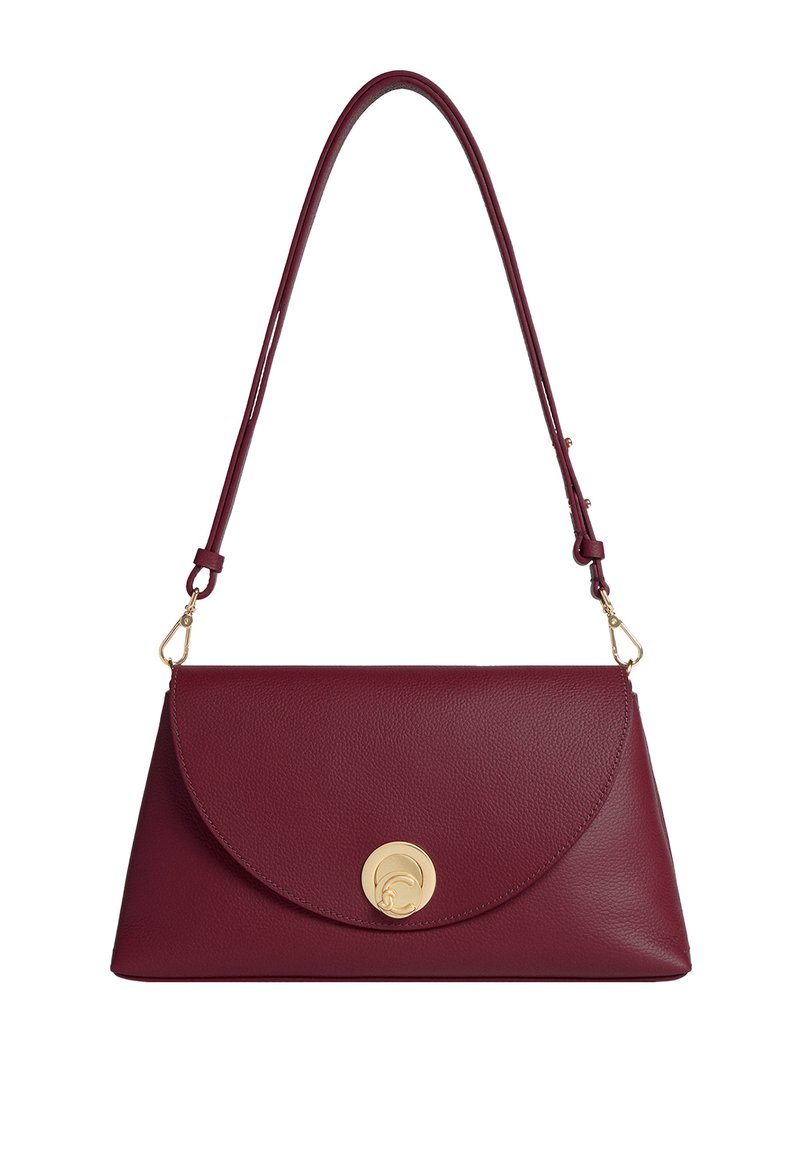 Borsa in pelle bordeaux con una pattina arrotondata e una chiusura circolare dorata. Dotata di una sola tracolla regolabile. Texture liscia.