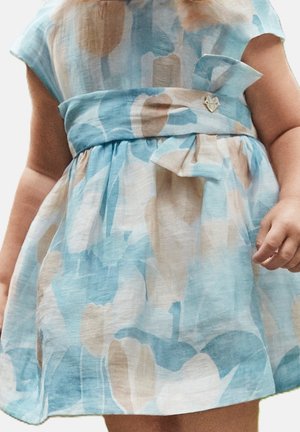 Robe bleu clair avec motifs abstraits beige et aqua, manches courtes, un détail de nœud à la taille, et un petit bouton en forme de cœur.