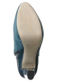 Teal suede high-heeled shoe with a glossy black patent leather accent. Smooth sole with slight wear, featuring branding and size.