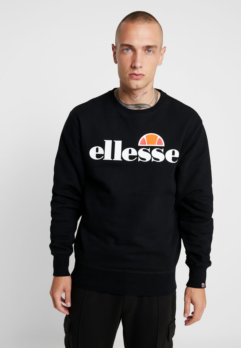 Schwarzer Sweatshirt aus Baumwolle mit rundem Halsausschnitt, der ein auffälliges weißes Logo "ellesse" und ein farbenfrohes Halbsonnen-Design über dem Text zeigt.