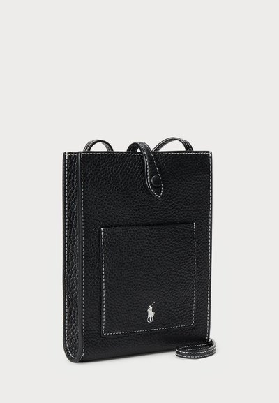 Μαύρη δερμάτινη τσάντα χιαστί με υφή, λευκές ραφές, μπροστινή τσέπη και λογότυπο. Ασφαλίζεται με χερούλι και λουρί.