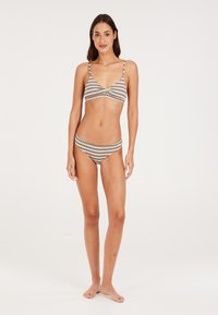 Prugasti bikini set s trokutastim vrhom s podesivim trakama i donjim dijelom niskog struka u pastelnim bojama s mekim teksturom.