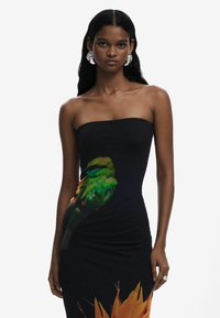 Black strapless dress featuring a vibrant green parrot graphic and orange floral accents. Slim fit with a smooth, textured fabric.