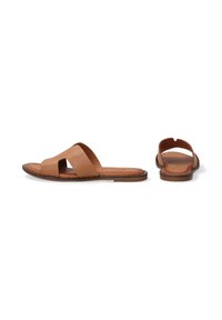 Tan leather slide sandals with two wide upper straps, open toe, and a flat sole. Minimalist design with a natural finish.