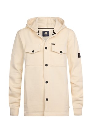 Crème-kleurige hoodie-jack van zacht materiaal. Kenmerkt zich door zwarte knopen, twee borstzakken en een logo-opdruk op de linker mouw.
