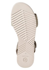 Tamaris Sandalensohle aus strukturiertem, hellbeigem Gummi mit Zickzackmuster und geprägtem Logo. Steife Konstruktion mit leicht erhöhtem Absatz.