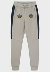 Grijze joggers met zwarte zijkanten, elastische tailleband en trekkoord. Voorzien van twee geborduurde patches, één met een aap en één met een rond logo.