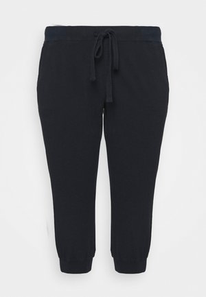 Černé bavlněné jogger kalhoty s elastickým pasem na šňůrku, bočními kapsami a elastickými manžetami na kotnících, s hladkou texturou a neformálním designem.