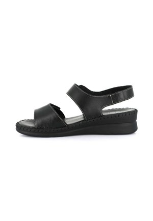 Sandalo nero in pelle con punta aperta, suola cucita, cinturino regolabile alla caviglia e tacco basso a zeppa per uso casual.