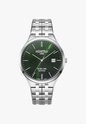 Nerūsējošā tērauda pulkstenis ar zaļu ciparnīcu, sudraba stundu atzīmēm, datuma rādītāju 3 stundās un elegantas aproces dizainu.