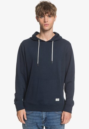 Navy blue cotton sweatshirt with a front pocket, adjustable drawstring hood, and ribbed cuffs. Features a small brand label at the hem.