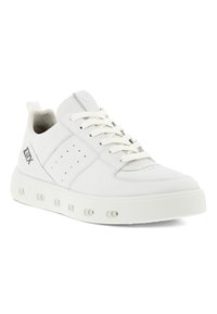 Sneaker bianco con upper in sintetico liscio, tallone testurizzato, sei fori per i lacci e dettagli a pois sui lati, dotato di una spessa suola in gomma bianca.