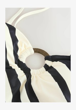 Top bikini a strisce nere e crema con un accentuazione circolare marrone, caratterizzato da tessuto arricciato sul colletto e spalline regolabili.