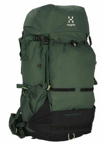 Sac à dos de randonnée en nylon vert avec une partie inférieure noire, plusieurs sangles réglables et une fermeture à cordon au sommet. Présente le texte "Rugged Mountain 75".