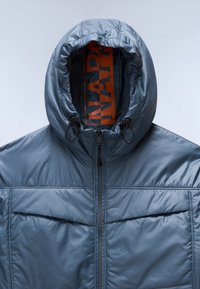 Blue padded jacket with a high collar and drawstring hood. Features zip closure and front pockets, made of shiny, lightweight fabric.